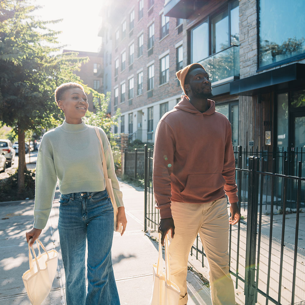 A couple is walking on the street in Brooklyn, New York City.